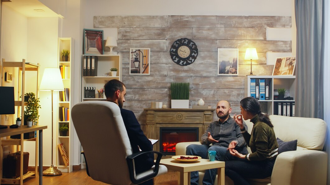 A professional consultant meeting with a couple in a modern living room.